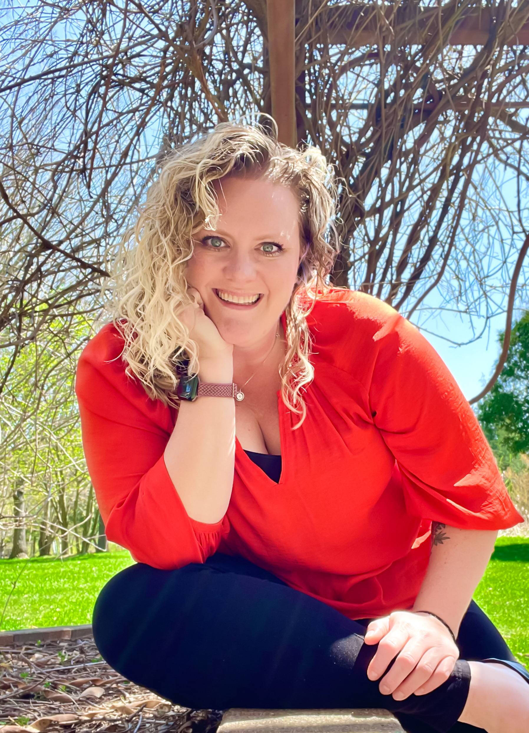 Photo of Keigh-Cee Bell sitting on a bench outside